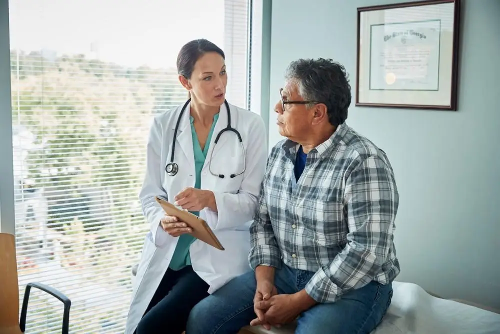 Doctor consulting with an older male patient in a medical office