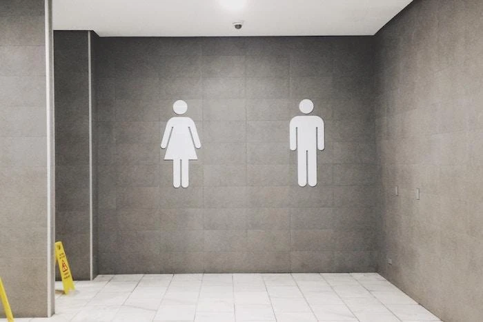 Restroom symbols for men and women on a wall